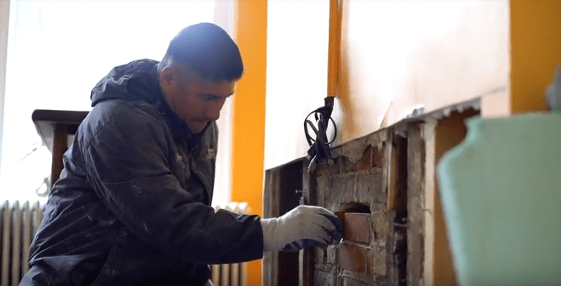 technician working hard on a fireplace