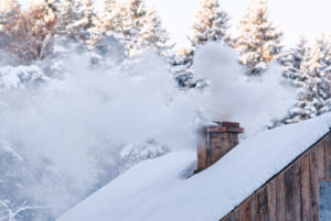 snowy roof with masonry chimney