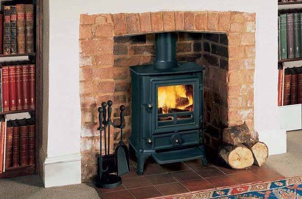 Black Gas Stove with Blazing flames set in an existing brick firebox with white mantle
