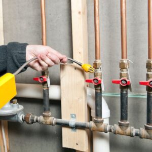 a hand installing gas lines