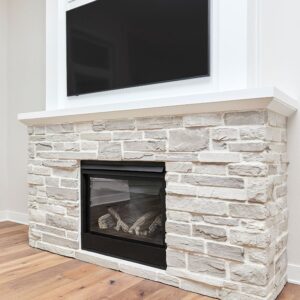 a gas fireplace in a white brick fireplace surround near a window