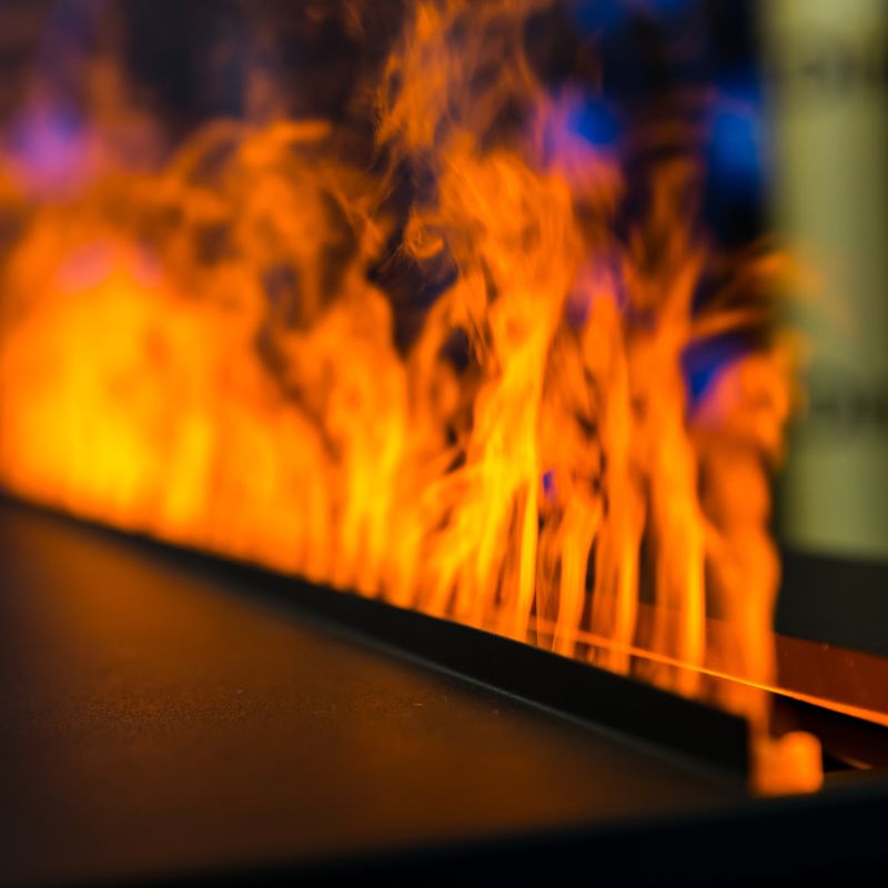 stock photo of gas flames line of very orange flames coming out of a gas heating appliance