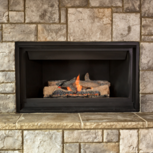a gas fireplace surrounded by gray masonry