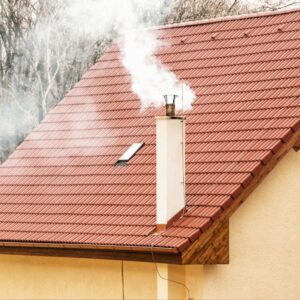 some coming out of a white chimney on a red roof