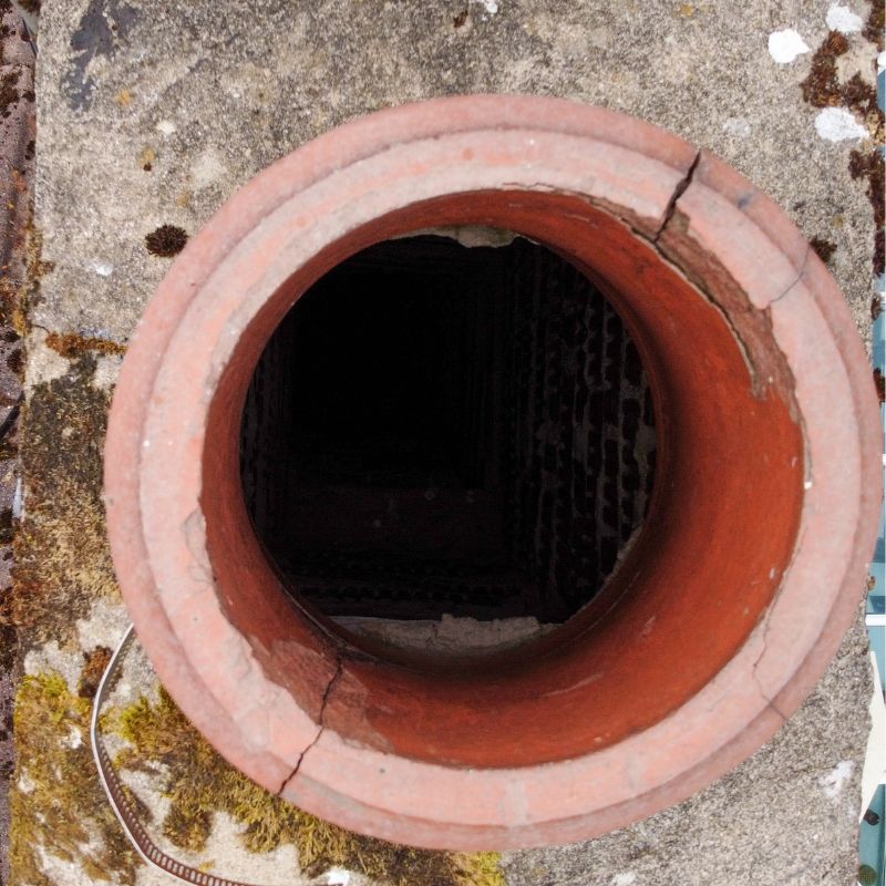 a view from the top looking into a clay pot flue