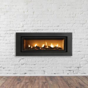 a wide gas fireplace in a white brick wall